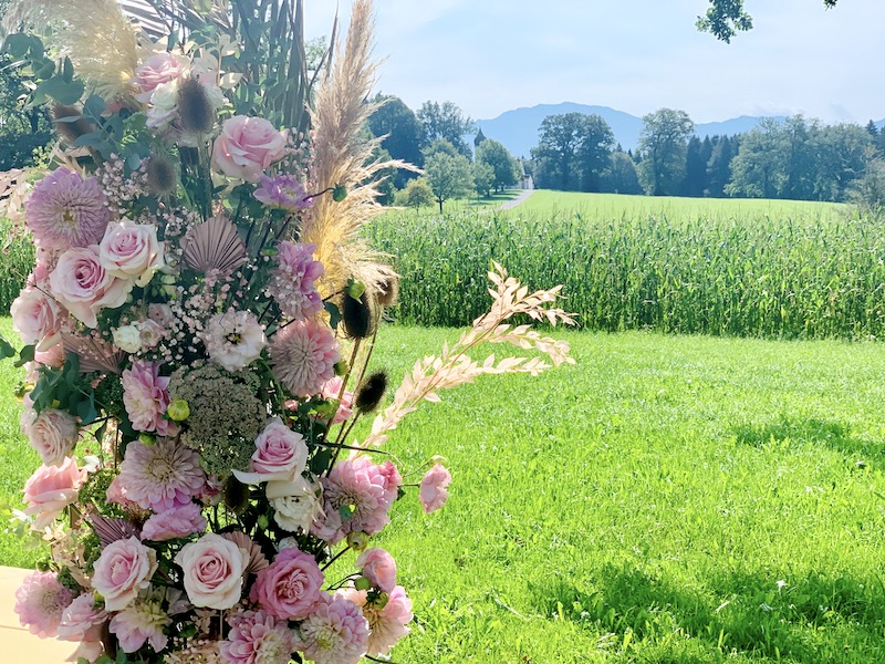 Hochzeitsbogen mit Blumen am Feld